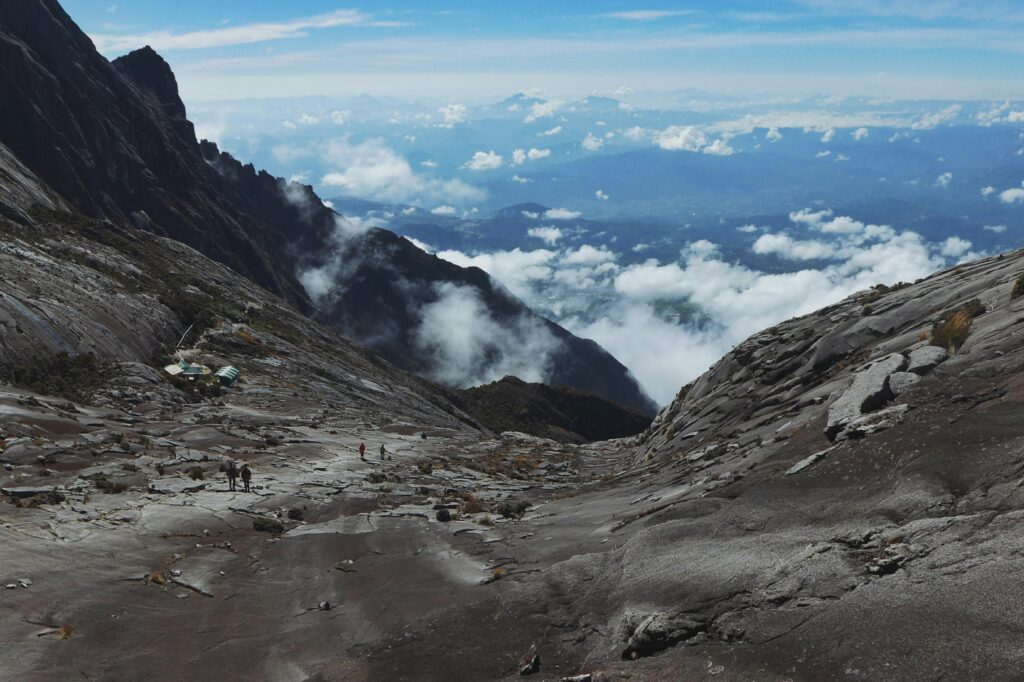 Breathtaking view of the rocky landscape and clouds at Mount Kinabalu, Ranau, Malaysia.